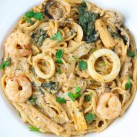 Creamy Tom Yum Pasta with seafood in a white plate