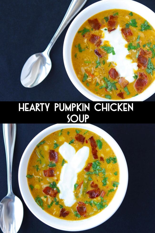 Two diagonally placed bowls of Pumpkin Chicken Soup garnished with chopped coriander, yogurt, and crispy bacon pieces. Two spoons on the side of bowls.