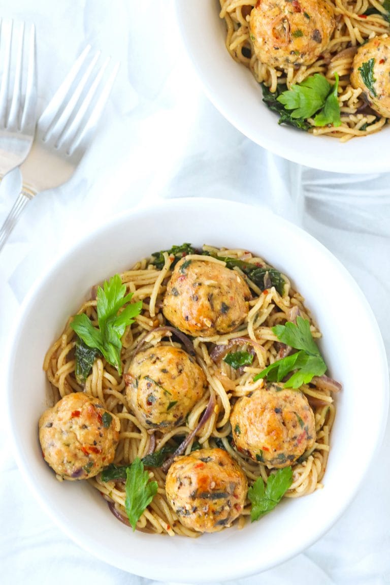 Brown butter miso pasta with spicy chicken meatballs in bowls.