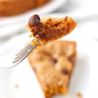 Fork holding up a bite of chocolate chip cookie cake.