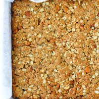 Apricot Almond Oat Slice baked slab in baking pan on top of cooling rack.