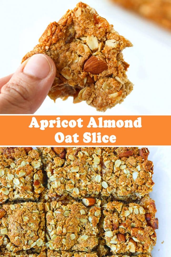 Hand holding up an apricot and almond oat slice with a bite taken out of it, and apricot almond oat bars on parchment paper.