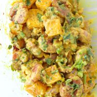 Cajun shrimp, cubed mango, creamy spicy mango mayonnaise, chopped coriander, spring onion, and walnuts tossed together in a large mixing bowl.