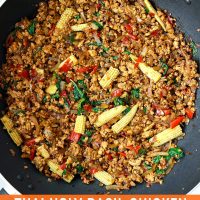 Thai holy basil chicken stir-fry with baby corn in a large wok.