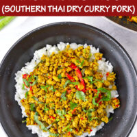 Top view of ground pork stir-fry on rice in black bowl. Text overlay "Khua Kling Moo (Southern Thai Dry Curry Pork)".