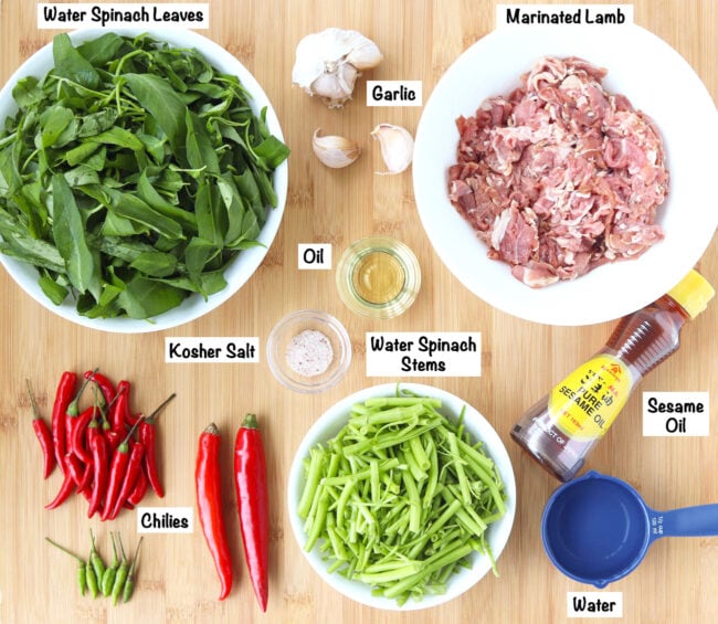 Labeled fresh ingredients for Taiwanese Lamb and Water Spinach Stir-fry on wooden board.