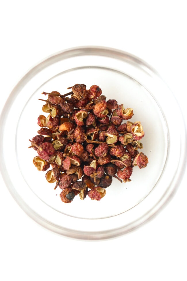 Top view of small bowl with Sichuan red peppercorns.