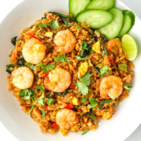 Top view of plate with spicy prawn fried rice. Text overlay "Thai Roasted Chili Fried Rice with Prawns" and "thatspicychick.com".