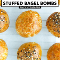 Close-up of bagel bombs lined up on parchment paper. Text overlay "Greek Yogurt Dough Stuffed Bagel Bombs" and "thatspicychick.com".