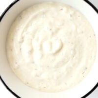 Close-up top view of garlic sauce in bowl. Text overlay "Kebab Shop Garlic Sauce" "With Mayo and Yogurt", and "thatspicychick.com".