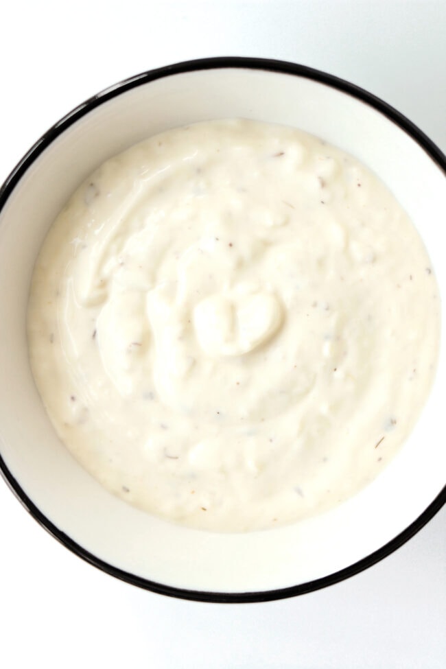 Garlic sauce in bowl and close-up of chicken shish. Text overlay