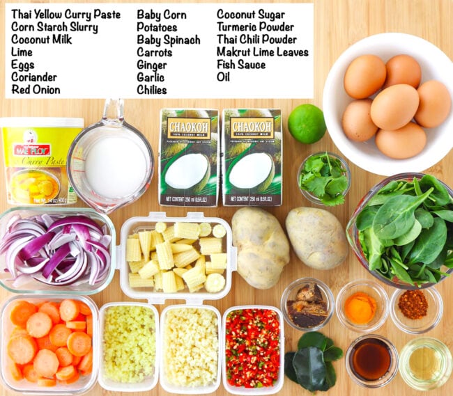 Labeled ingredients for Thai Yellow Egg Curry on a wooden board.