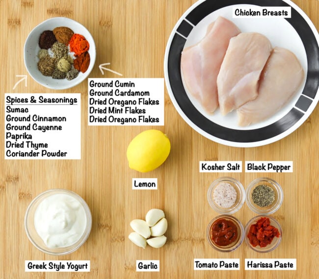 Labeled ingredients for chicken shish marinade on a wooden board.