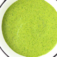 Close-up top view of bowl with green sauce. Text overlay "Cilantro and Mint Sauce", "Creamy Kebab Shop Style Sauce!", and "thatspicychick.com".