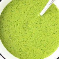 Bowl with green sauce and a spoon. Text overlay "Cilantro and Mint Sauce", "Creamy Kebab Shop Style Sauce!", and "thatspicychick.com".