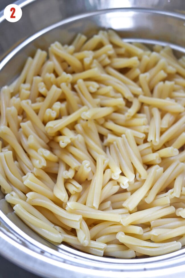 Cooked gemelli pasta in a colander.