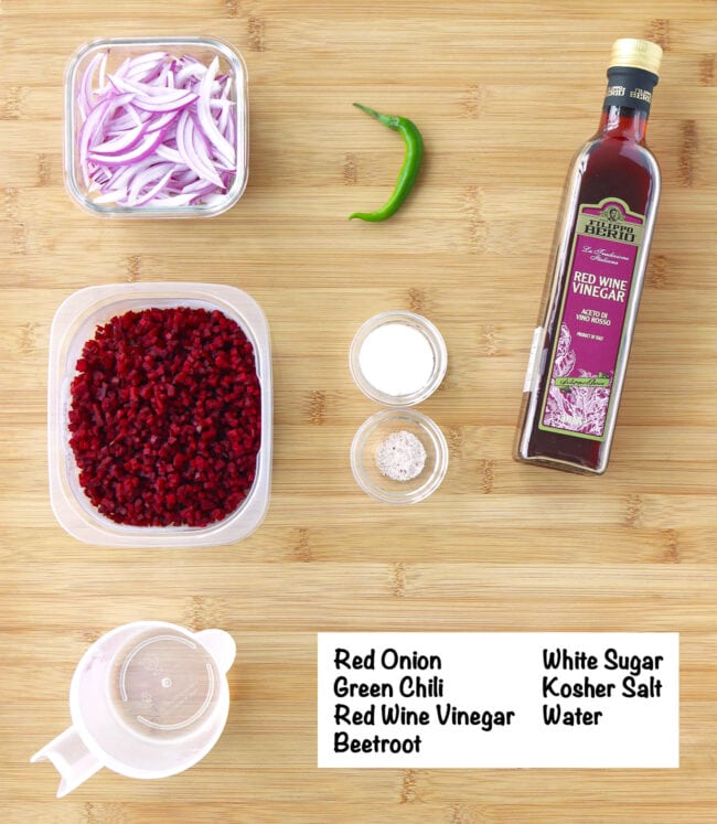 Labeled ingredients for pickled red onion and beetroot relish on a wooden board.