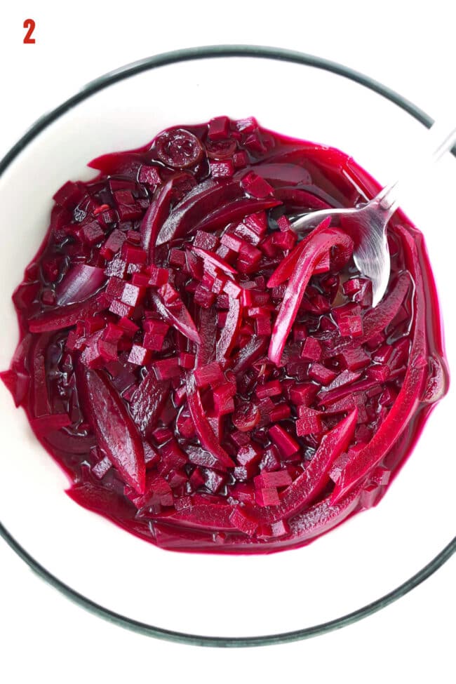 Pickled red onion and beetroot relish in a bowl with a spoon.