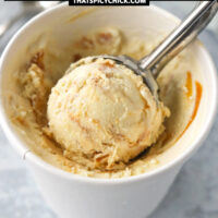Ice cream in and scooper in a paper carton. Text overlay "Baileys Salted Caramel Peanut Butter Ice Cream (No Churn)" and "thatspicychick.com".