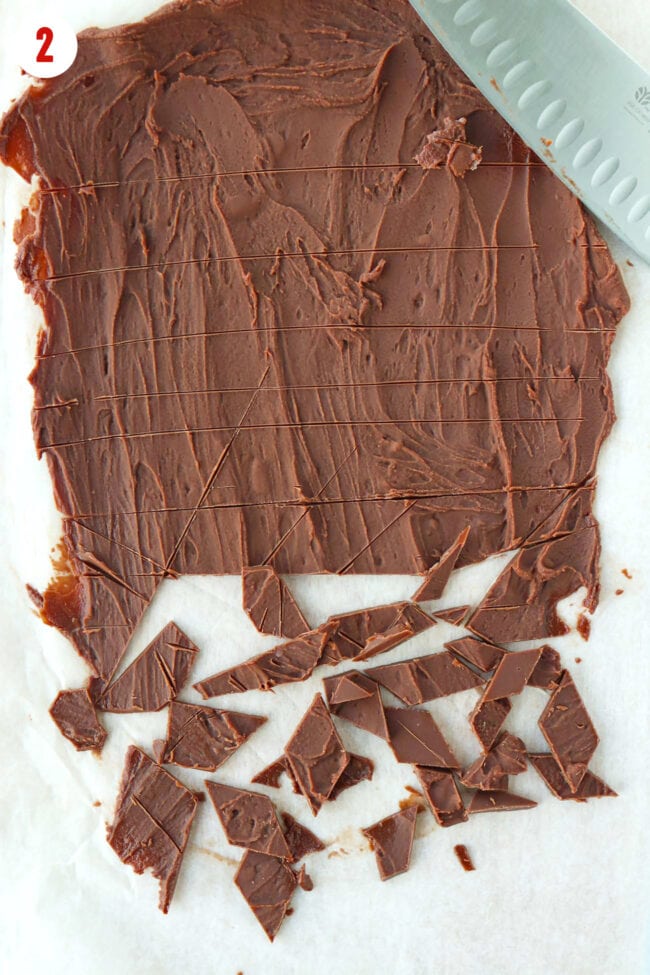 Chocolate shards on parchment paper sheet with a knife.