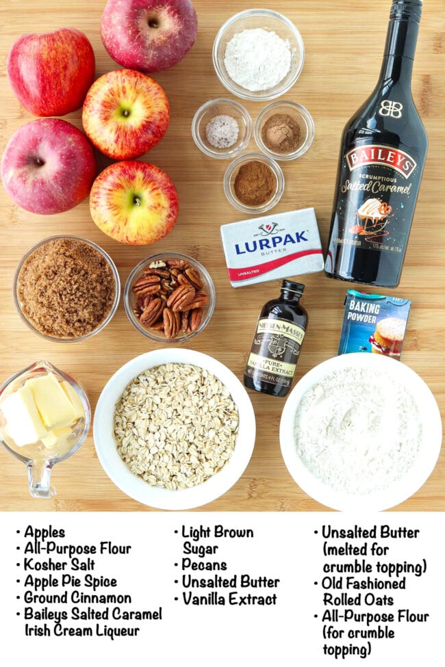 Labeled ingredients for Baileys Salted Caramel Apple Crumble on wooden board.