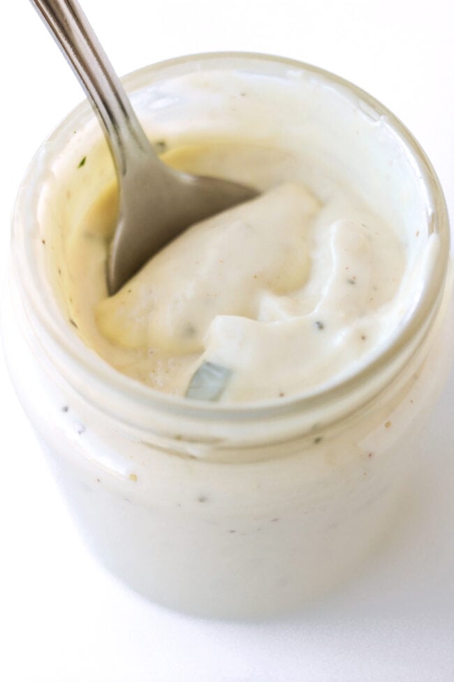 Spoon inside of jar with dressing.