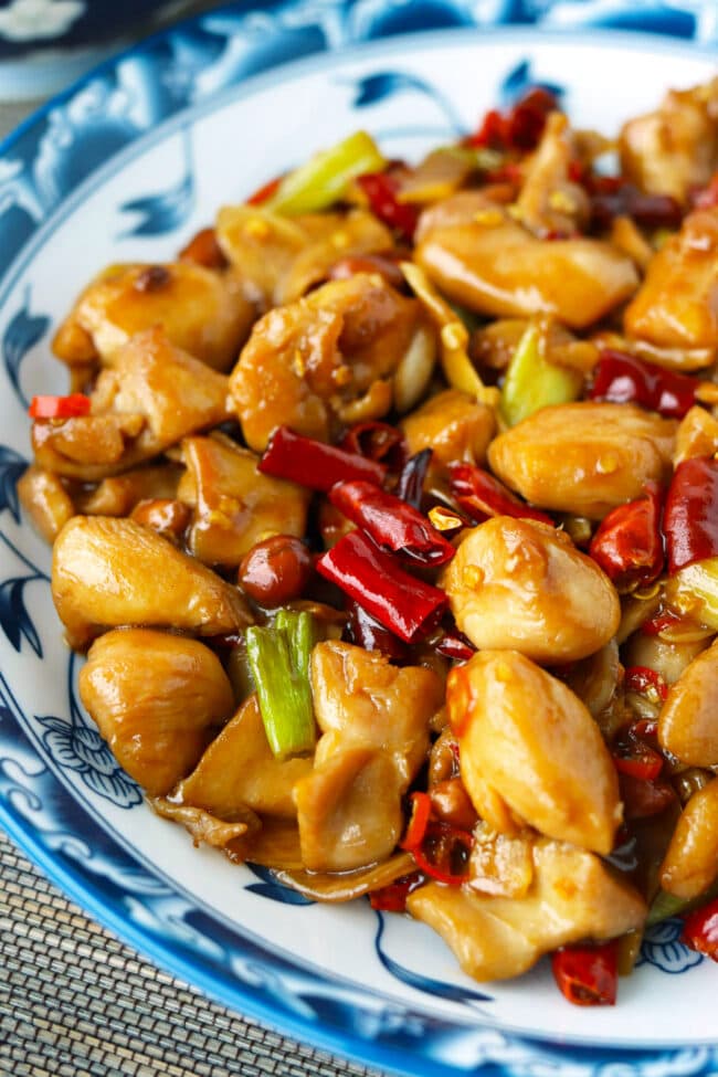 Closeup front view of Kung Pao Chicken on a serving plate.