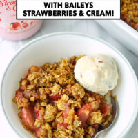 Bowl with strawberry crisp, ice cream scoop, and spoon. Text overlay "Strawberry Crisp", "thatspicychick.com, and "with Baileys Strawberries & Cream!".