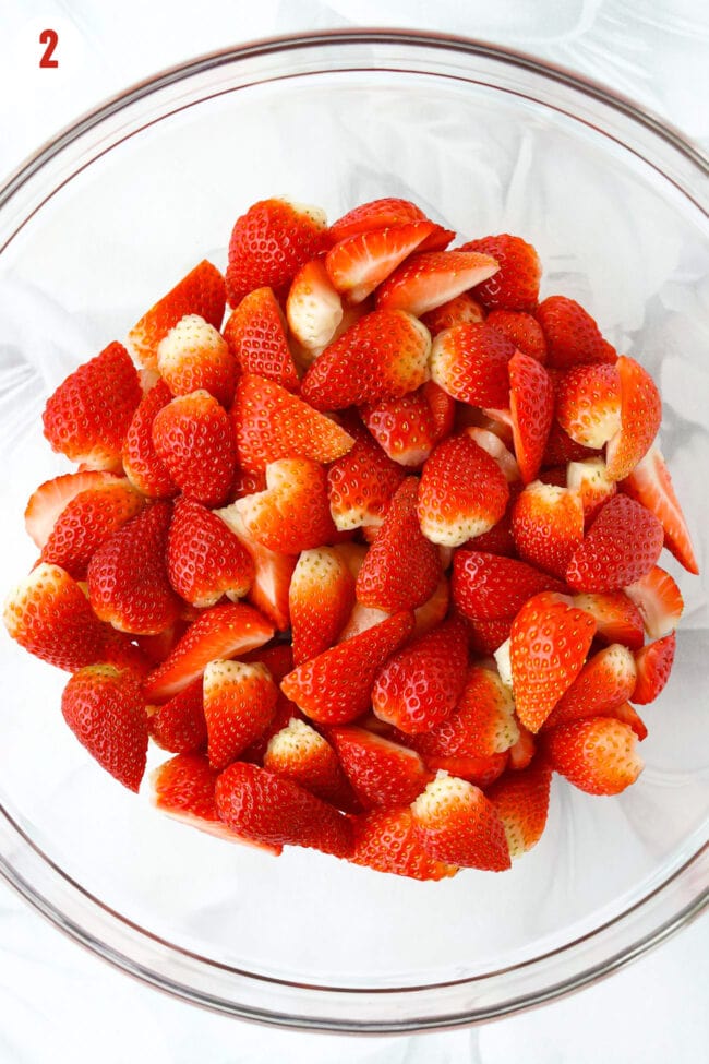 Sliced strawberries in a mixing bowl.