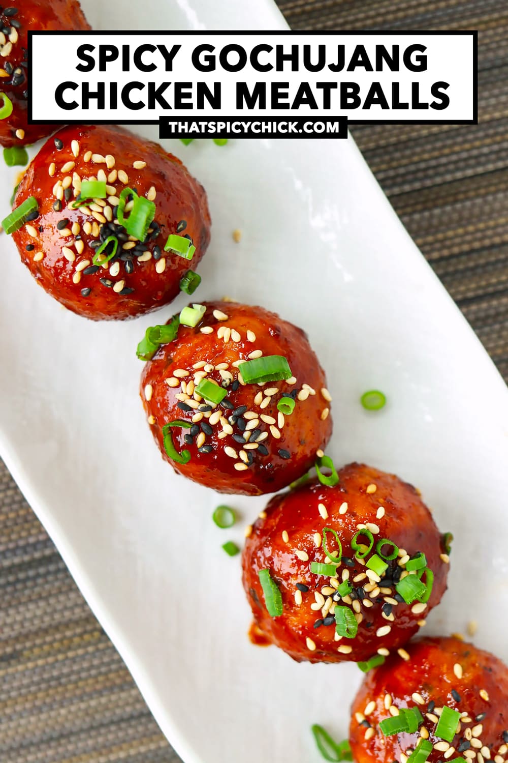 Top view of plate with spring onion and sesame seeds garnished spicy meatballs. Text overlay "Spicy Gochujang Chicken Meatballs" and "thatspicychick.com".