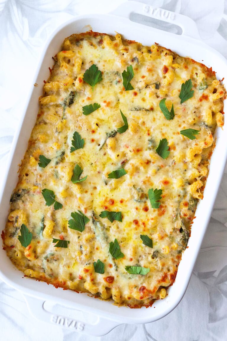 Tuna pasta bake with cheesy topping in a casserole dish.