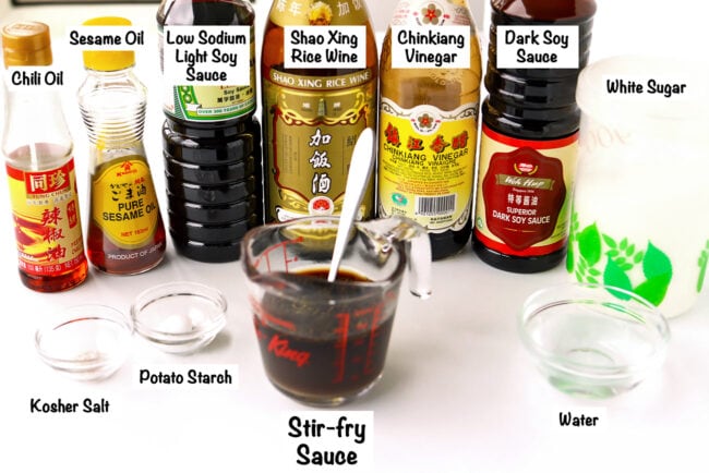 Labeled sauce ingredients and stir-fry sauce in a measuring cup for Yu Xiang Chicken.