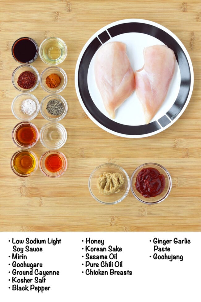 Labeled ingredients for spicy gochujang chicken marinade on a wooden board.