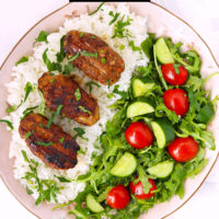 Kofta over rice with salad on a plate. Text overlay "Spicy Lamb & Chicken Kofta" and "thatspicychick.com".
