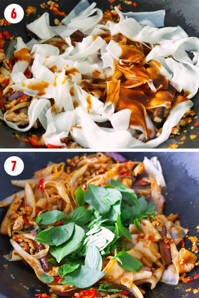 Noodles in wok with sauce poured on top. Basil on stir-fried noodles.