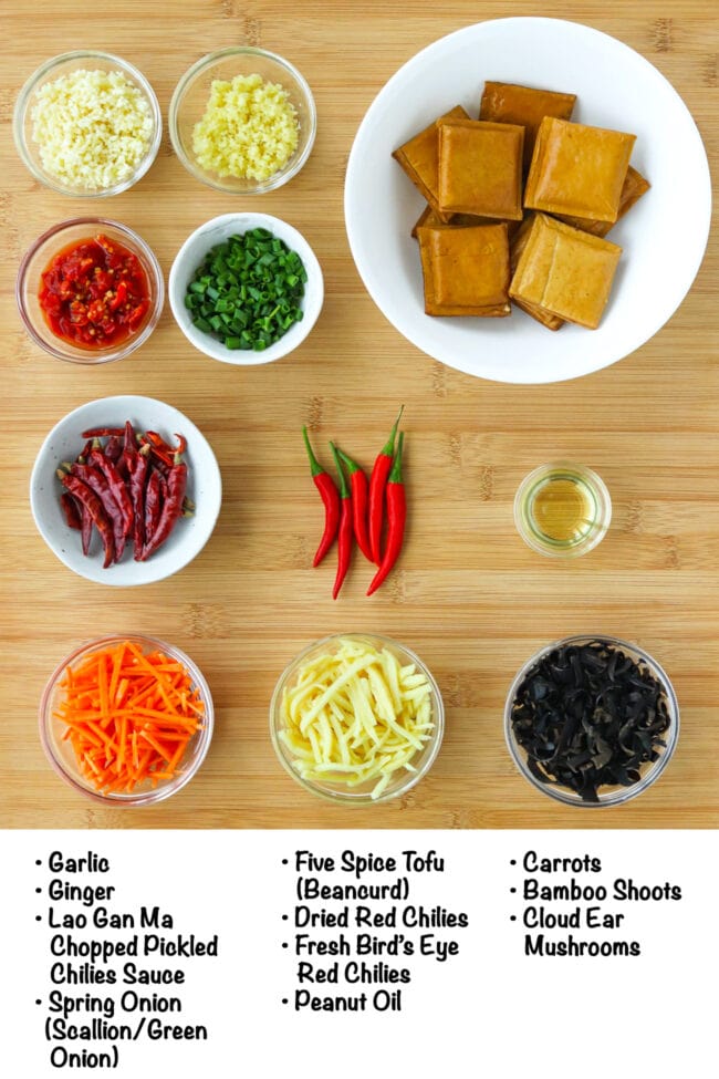 Labeled ingredients for Tofu with Hot Garlic Sauce (Sichuan Yu Xiang Tofu) on a wooden board.