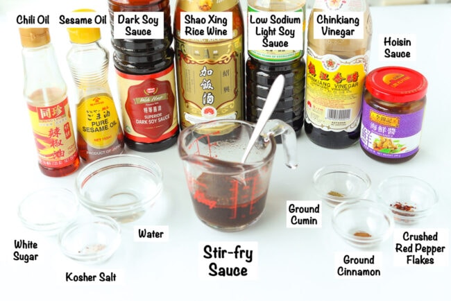 Labeled sauce bottles and seasonings for Mongolian lamb stir-fry sauce.