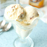 Ice cream scoops in a dessert glass. Disaronno Velvet bottle behind.