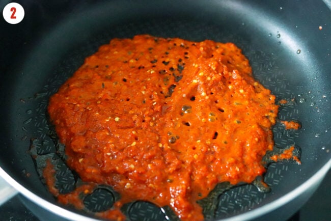 Frying chili paste in pan.