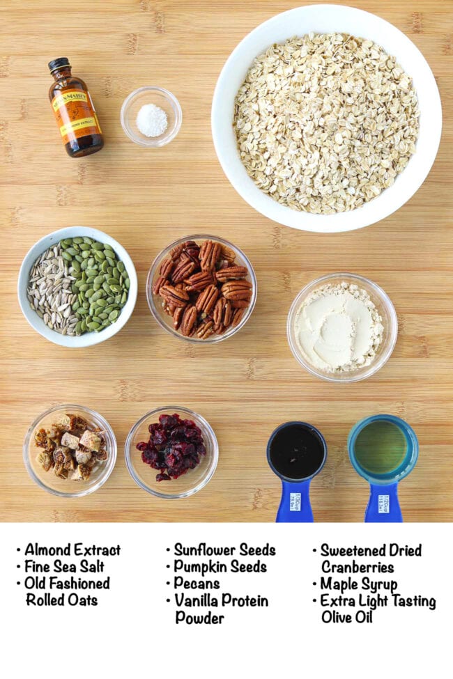 Labeled ingredients for high protein granola on a wooden board.