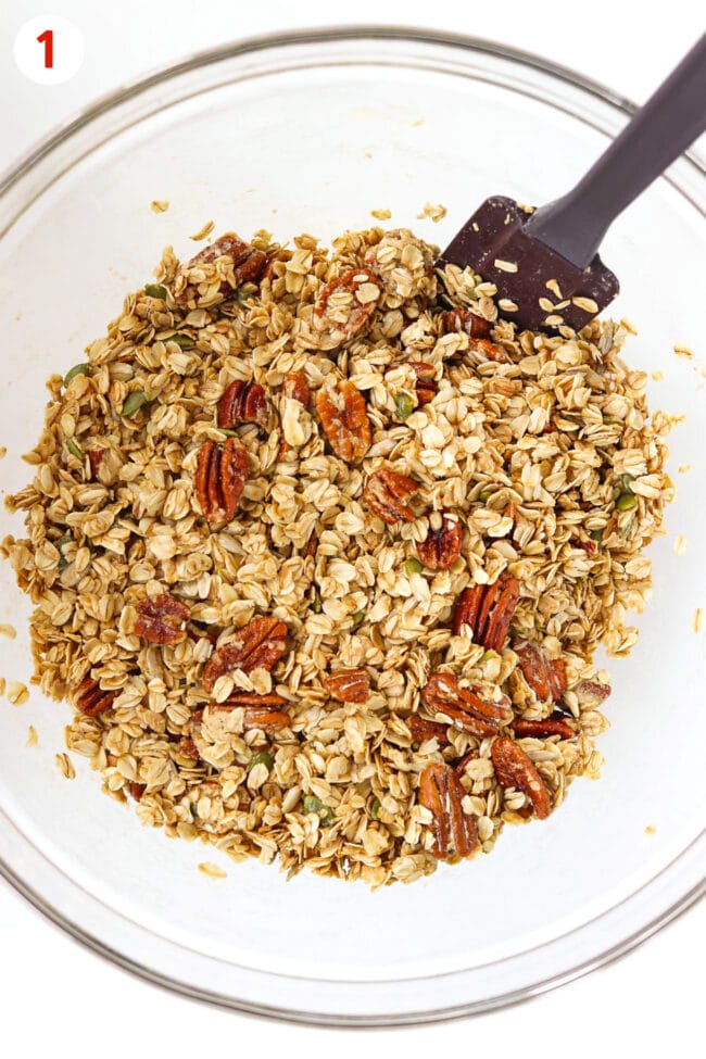 Mixing bowl with combined oats, pecans, seeds, protein powder, maple syrup and oil mixture.