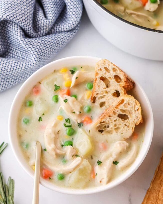 Chicken pot pie soup in a bowl with a spoon.