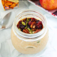 Pumpkin overnight oats in a jar with toppings. Text overlay "Pumpkin Spice Overnight Oats", "thatspicychick.com", and "High Protein, Easy | Healthy | Gluten-free".