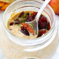 Overnight oats in a jar with toppings. Text overlay "Pumpkin Spice Overnight Oats", "thatspicychick.com", and "High Protein, Easy | Healthy | Gluten-free".