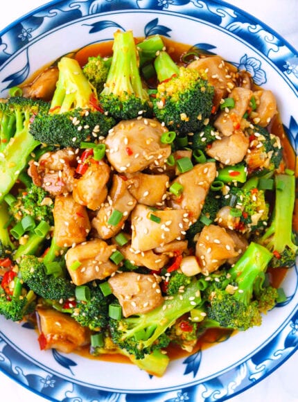 Closeup top view of plate with spicy chicken and broccoli stir-fry.