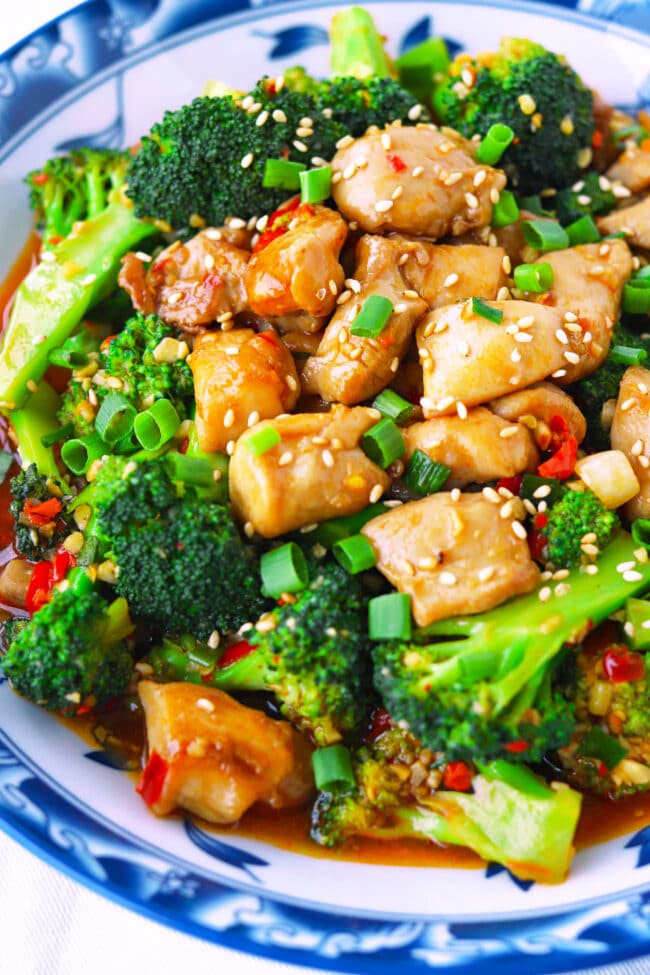 Closeup front view of plate with spicy chicken and broccoli stir-fry.