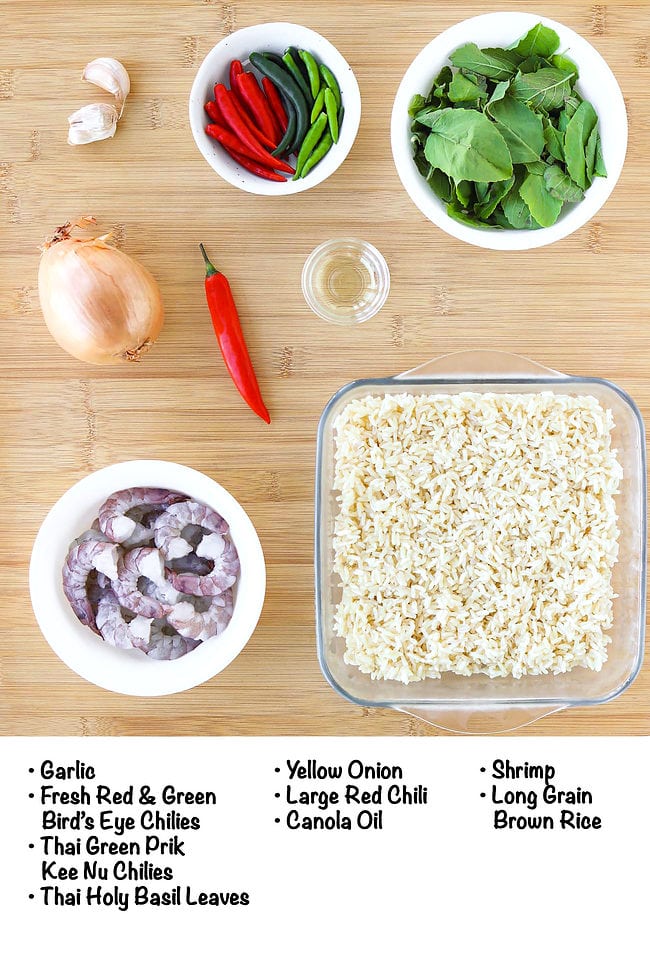 Labeled ingredients for Thai basil shrimp fried rice on a wooden board.