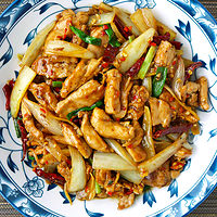 Top view of plate with a chicken stir-fry dish. Text overlay "Five Spice Chicken Stir-fry" and "thatspicychick.com".