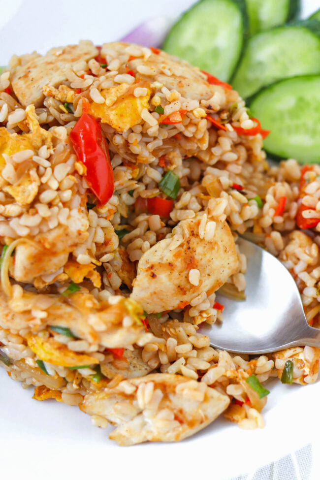 Closeup of Thai fried rice on a plate with a spoon.