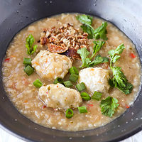 Front view of bowl with chicken congee. Text overlay "Thai Rice Porridge with Chicken Meatballs" and "thatspicychick.com".